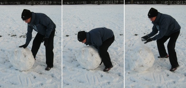 London snow, rolling giant snowballs in London's Regents Park