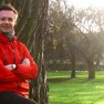 Reviewing workout programme against tree trunk in Regent's Park
